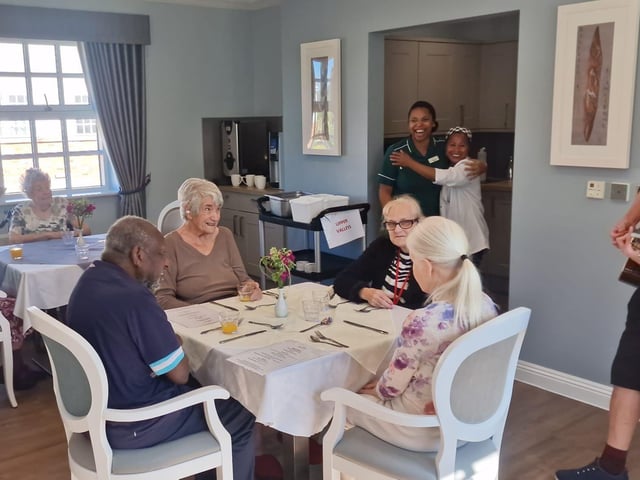 Greg Surprises residents and staff with an impromptu visit in the dining room.
