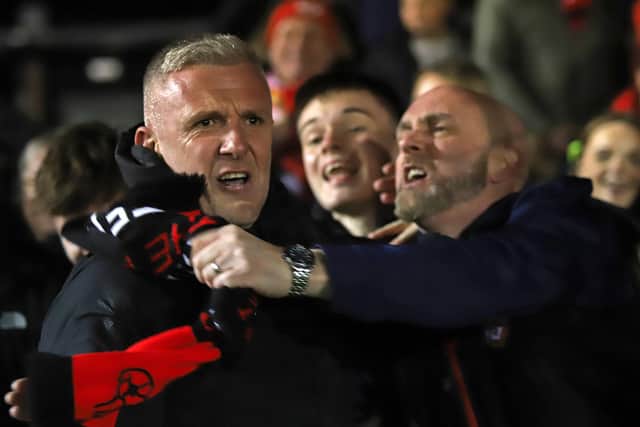 Richard Lavery celebrates with the Kettering fans after Tuesday night's win over Alvechurch