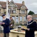 Cllr Adrian Winkle reads a poem to honour those who died