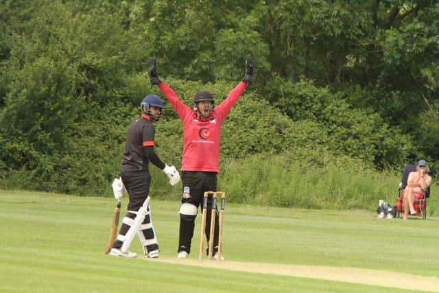 Kislingbury wicketkeeper Rob Collins goes up for an appeal against Brigstock