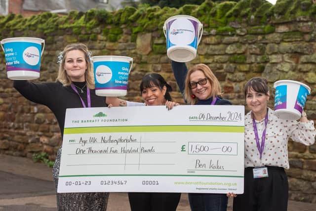 DWSM - SGB-54468 - Staff from Age UK Northamptonshire with their cheque from David Wilson Homes
