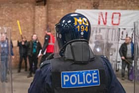 Riot police face mock protestors in a training exercise in a disused warehouse in Earls Barton