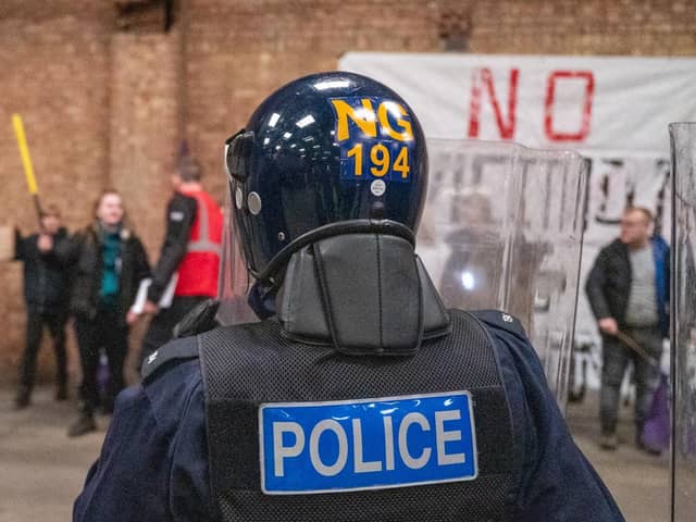 Riot police face mock protestors in a training exercise in a disused warehouse in Earls Barton