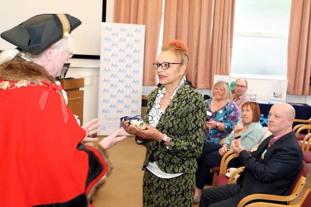 Anita Neil receives the scroll from Mayor of Wellingborough Cllr Lora Lawman