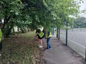 Youth volunteers avoiding overgrown trees outside Hazel Leys Youth club.