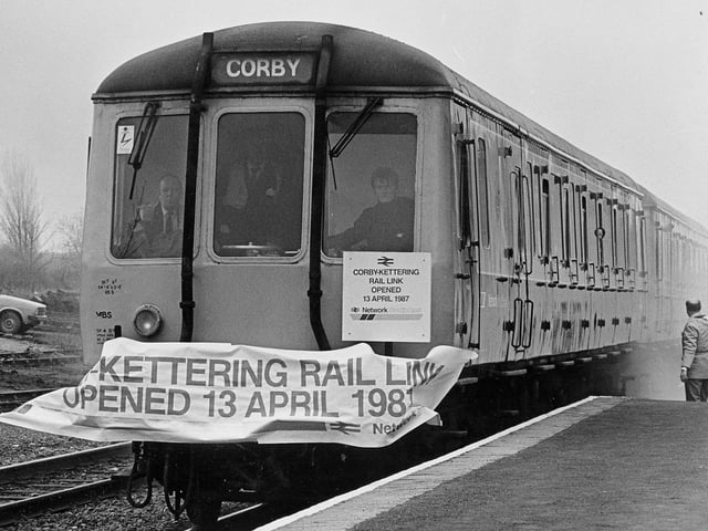 To the sound of firecrackers and the breakaing of a banner across the line, the train arrives from Kettering for the official opening of the Corby-Kettering rail link in 1987