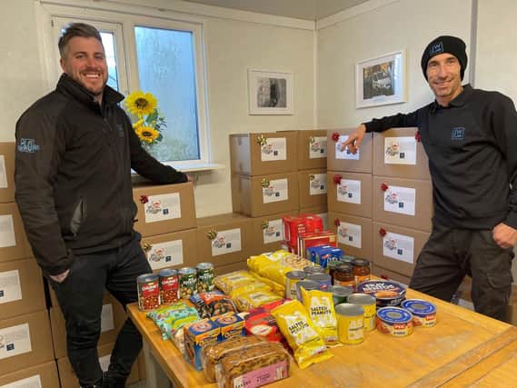 JW Clark Ltd employees, transport co-ordinator Chris Jones and driver Gary Landon, with Christmas food parcels made to distribute to elderly people in the Irthlingborough area