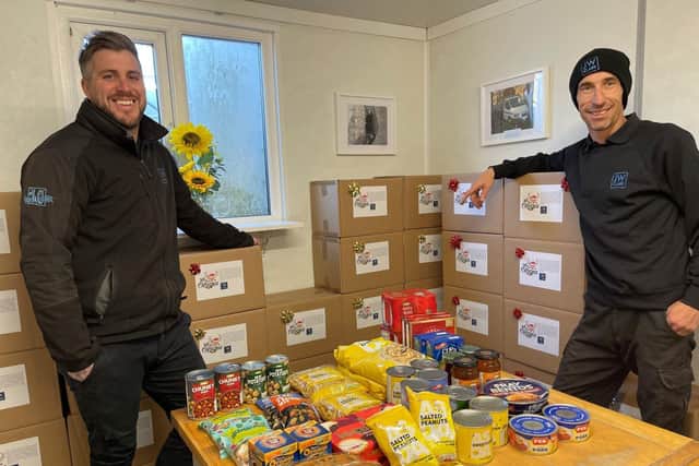 JW Clark Ltd employees, transport co-ordinator Chris Jones and driver Gary Landon, with Christmas food parcels made to distribute to elderly people in the Irthlingborough area