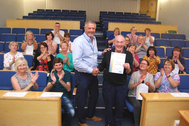 Ralph receives his 60 years of service certificate from then Chairman Alan Burns in 2019