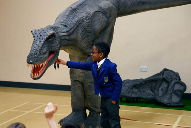 A pupil meets Reggie the animatronic T-Rex