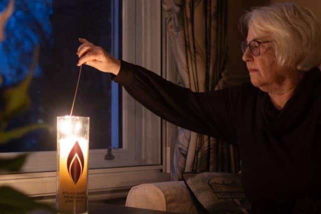 Image: Joan Salter MBE, a child survivor of the Holocaust, lighting a candle for Light the Darkness 2024 © Sam Churchill / Holocaust Memorial Day Trust.