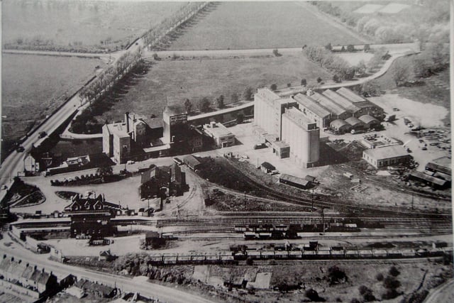 Aerial photo showing the London Road entrance to Wellingborough.  Whitworths Mill, Wellingborough London Road Station where the A45 now goes along the path of the old railway line and where Tesco was built.  The photo is believed to be from the 1950s and shows the avenue of lime trees