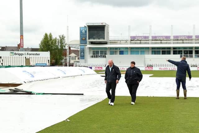 The umpires and ground staff inspect the square at the County Ground on Monday (Photo by David Rogers/Getty Images)