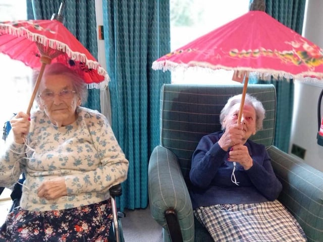 Happy Chinese New Year: Two residents holding their parasols.