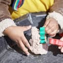Children's hands, playing with a cookie cutter