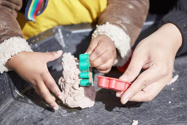 Children's hands, playing with a cookie cutter