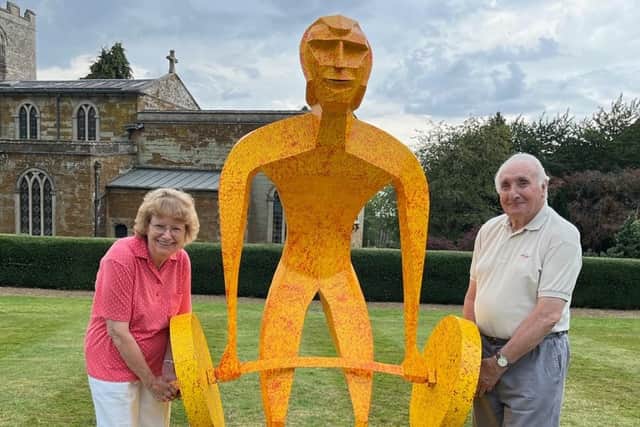 Mick Henson's parents with their son's weightlifter sculpture