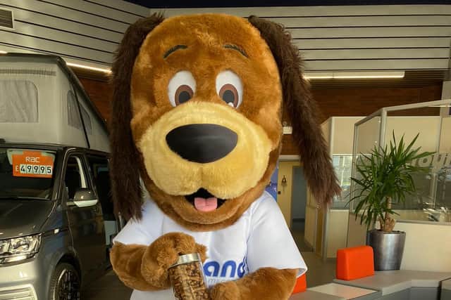 Croyland Car Megastore's mascot Cooper the Dog pictured with his jar of dog biscuits