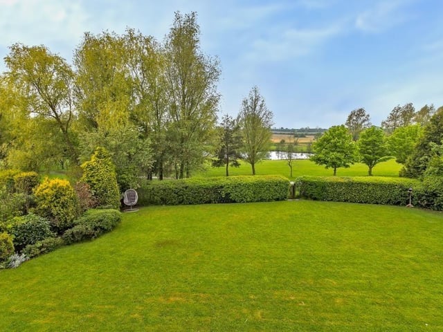 The gorgeous rear garden backs onto Collingtree Golf Course, with stunning views of its lake