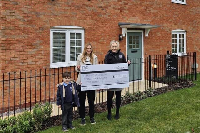 Friends of Higham Ferrers Nursery and Infant School PTA Chair Nicole Boto and her son Arlie Boto join Jess Eastaway, Sales Negotiator at HarperCrewe's Higham Ferrers development, to receive their Community Fund donation.