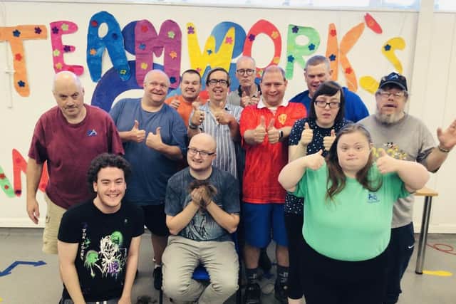 Sam (front centre) celebrates his hair-raising fundraiser with service users from Teamwork Trust