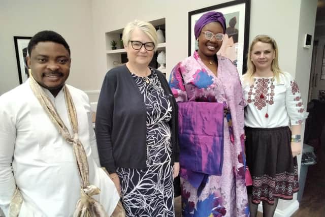 Manager Joanna and traditionally dressed staff