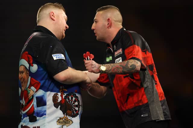 Ricky Evans is congratulated by Nathan Aspinall after his 3-0 win over the world number six on Saturday (Photo by Paul Harding/Getty Images)