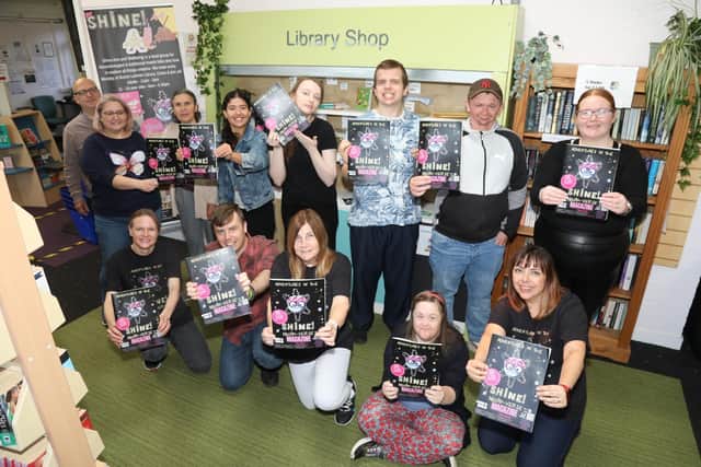 Shine! members and staff with their magazine