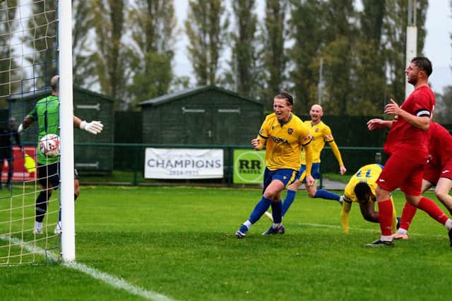 A tumbling Zayn Hakeem (no.11) heads home the winning goal for Wellingborough Town against Coleshill (Picture: Rob Webb)