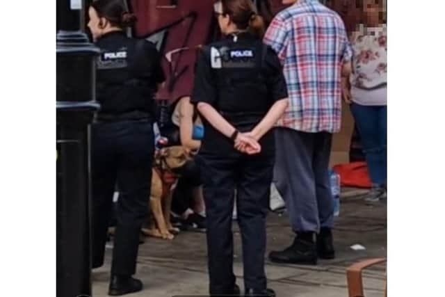 A muzzled dog was seen after the attack as police were talking to a group of people in High Street