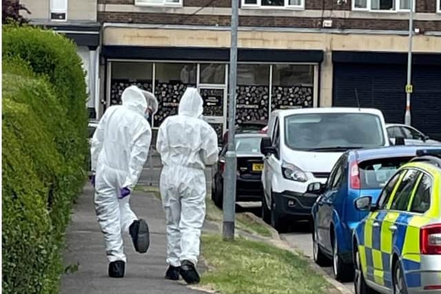 Forensics officers on the scene of the stabbing in Corby