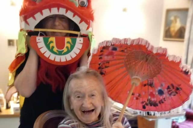 Residents and staff at the care home celebrating the Year of the Dragon.