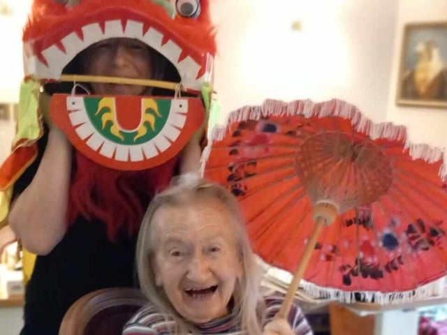 Residents and staff at the care home celebrating the Year of the Dragon.