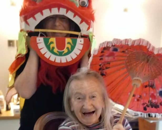 Residents and staff at the care home celebrating the Year of the Dragon.