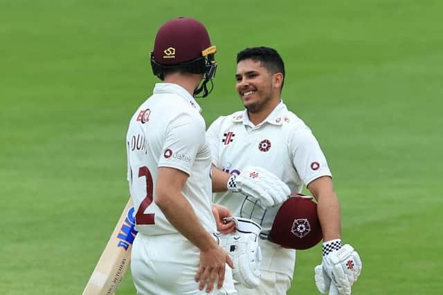 Ricardo Vasconcelos is all smiles as he celebrates reaching his century with batting partner Will Young