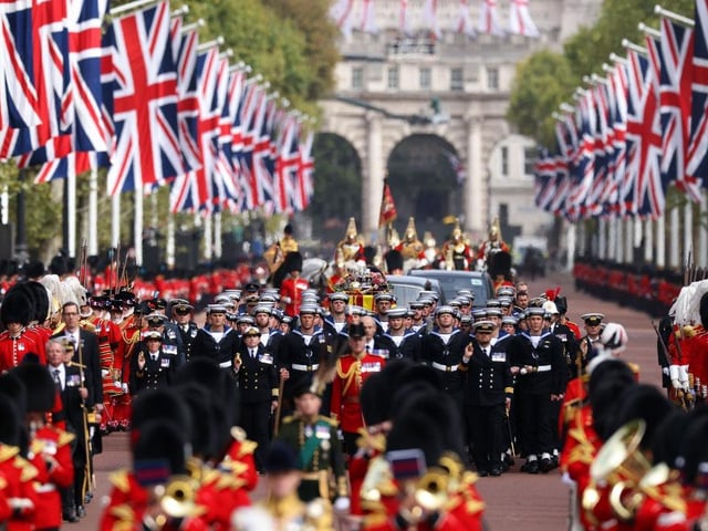 The Coldstream Guards travel along The Mall ahead of the Queen's coffin