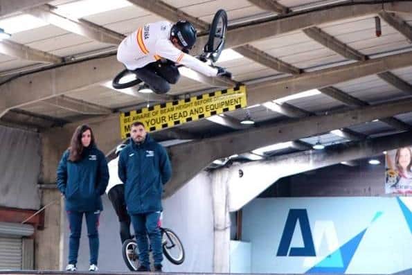 Spanish team rider performing a ‘Tabletop’ in front of coaches at Adrenaline Alley