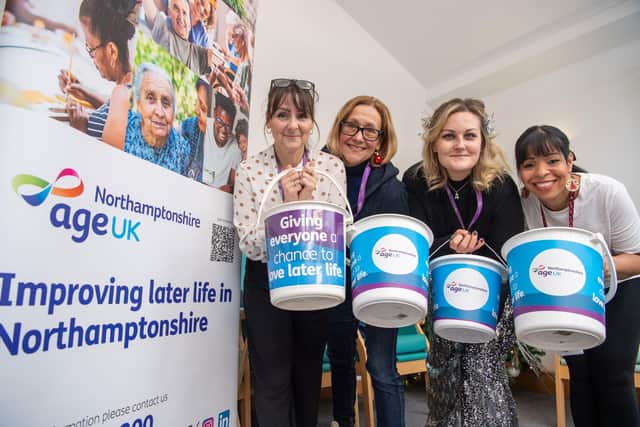 DWSM - SGB-54455 - Staff from Age UK Northamptonshire holding collection buckets