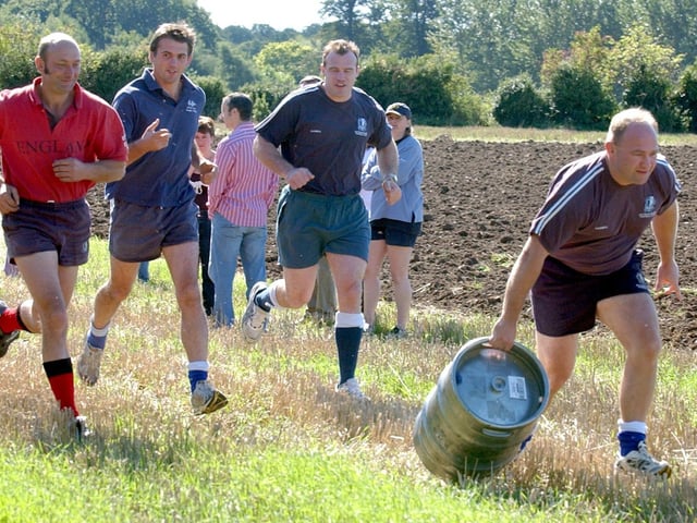 Geddington Kettering Rugby Club team, Jim Groome, takes the first leg pulling the empty beer barrel followed by his team mates, l-r Harvey Smith, Ed Dee, and Bill Drake-Lee. 2005