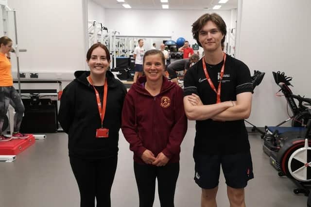 Lynne stood beside two UON students.