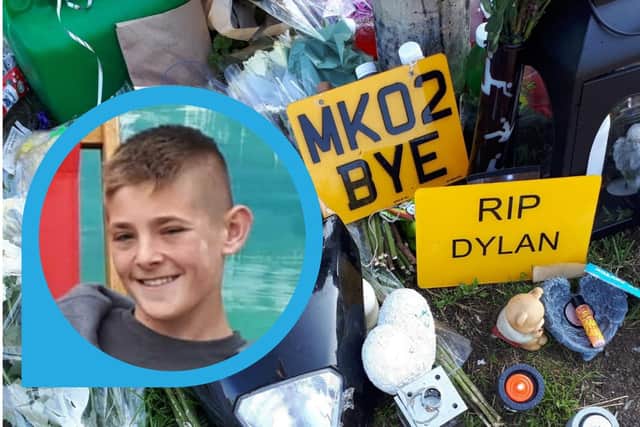 A family photo of Dylan Holliday with the floral tributes left near the A509 underpass last year