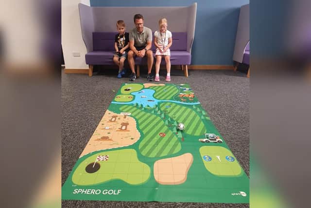 RS’ social impact partner manager James Tucker with his son, Henry, seven, and daughter, Olivia, eight, trying out OKdo’s Sphero Golf