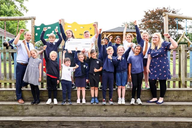 Cranford CE School pupils, staff and PTA members celebrate their windfall