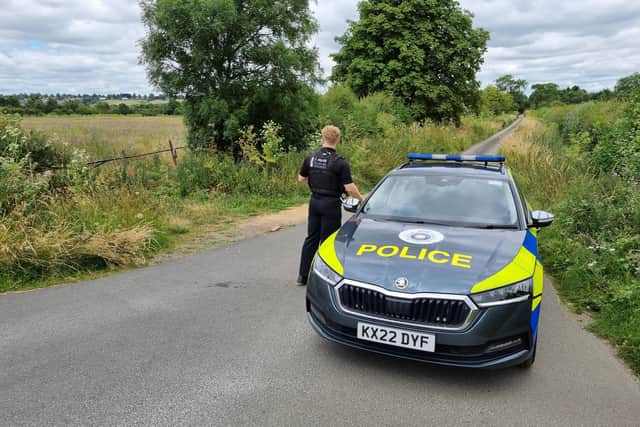 A police officer on guard at Summer Leys Nature Reserve