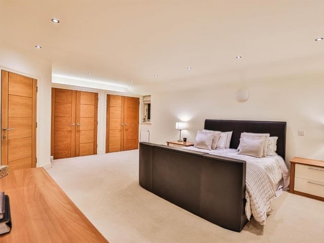 This modern family home is in a picturesque village and shares its boundary with a church.