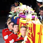 King Charles III and Prince William follow the coffin of Queen Elizabeth II out of Westminster Abbey after the State Funeral