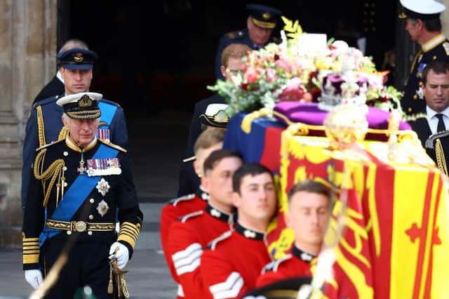 King Charles III and Prince William follow the coffin of Queen Elizabeth II out of Westminster Abbey after the State Funeral