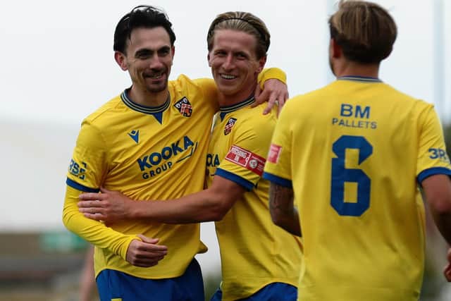 Ethan Johnston (left) of Wellingborough Town celebrates scoring his side's fourth goal against Corby Town on Saturday (Picture: Rob Webb)
