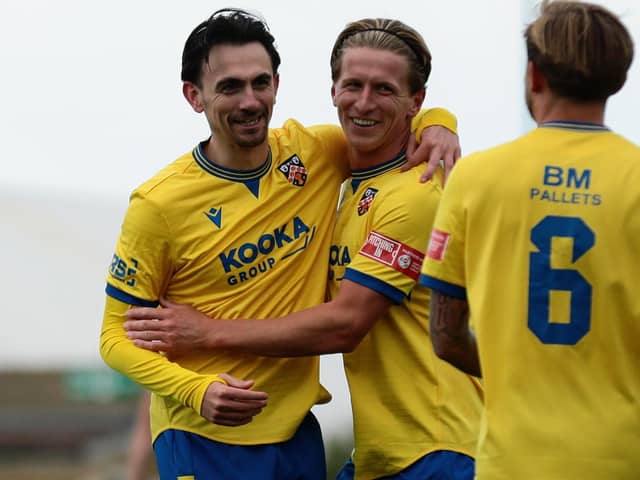 Ethan Johnston (left) of Wellingborough Town celebrates scoring his side's fourth goal against Corby Town on Saturday (Picture: Rob Webb)