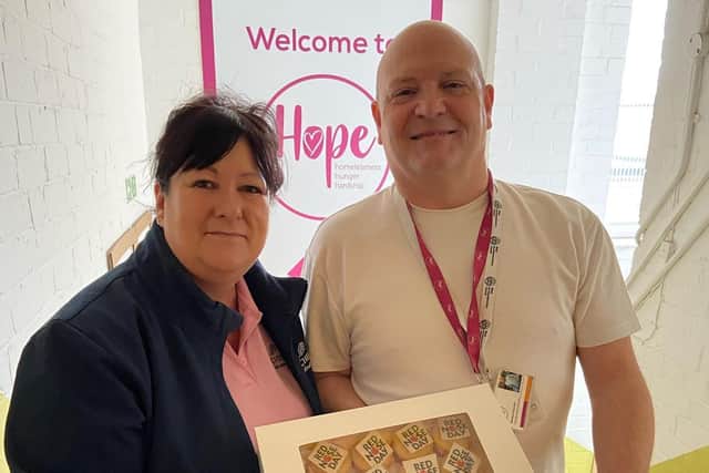 Julie presents cupcakes and biscuits to Matt, Sustainable Food and Partnership Manager at The Hope Centre